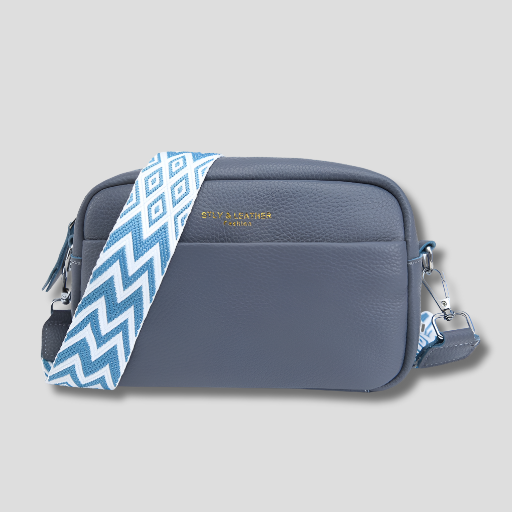 Chic blue women's handbag with a modern geometric strap design. An elegant and versatile purse for daily use.