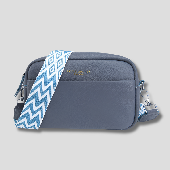 Chic blue women's handbag with a modern geometric strap design. An elegant and versatile purse for daily use.