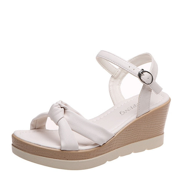 Stylish black women's platform wedge sandals with a secure ankle strap, perfect for summer holidays.