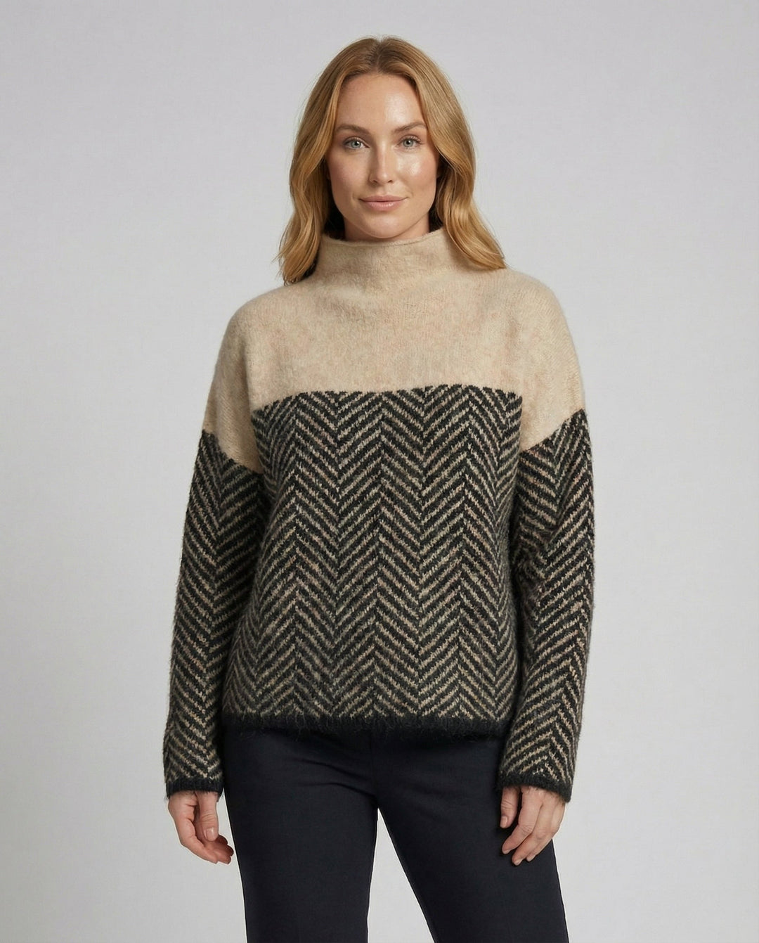 Close-up of the cozy knit texture on a women's warm turtleneck sweater, perfect for winter elegance.