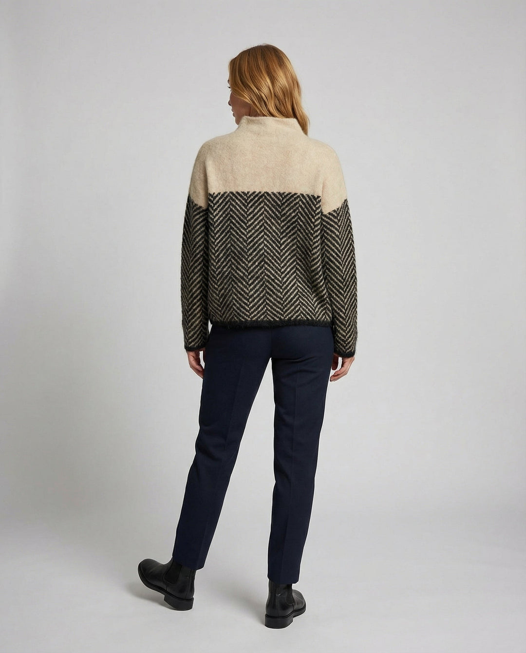 Woman wearing a long-sleeve cozy textured turtleneck sweater, ideal for casual wear and warmth.