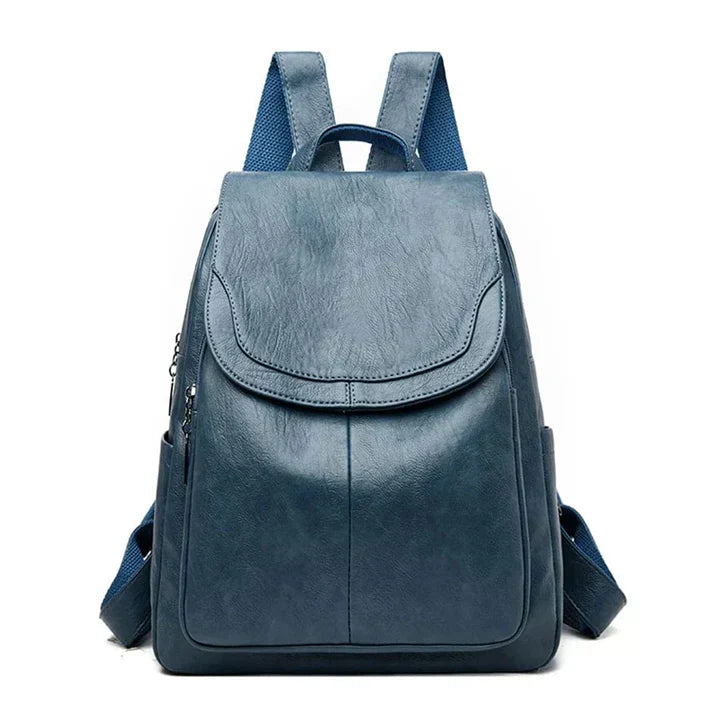 Detail of women's flap backpack: front buckle, spacious main compartment & adjustable shoulder straps.