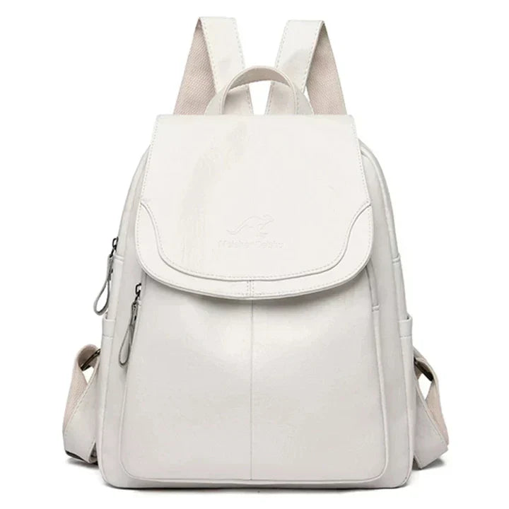 Woman carrying a stylish black flap backpack. Comfortable & chic for everyday errands or a quick trip.