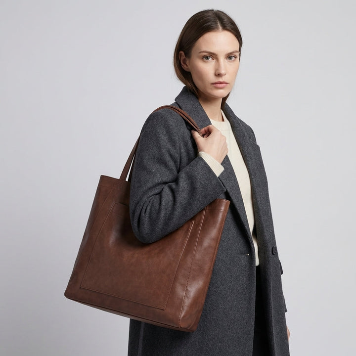 Brown large tote shoulder bag for women. Features an exterior pocket, ideal for daily use & as a stylish work bag.