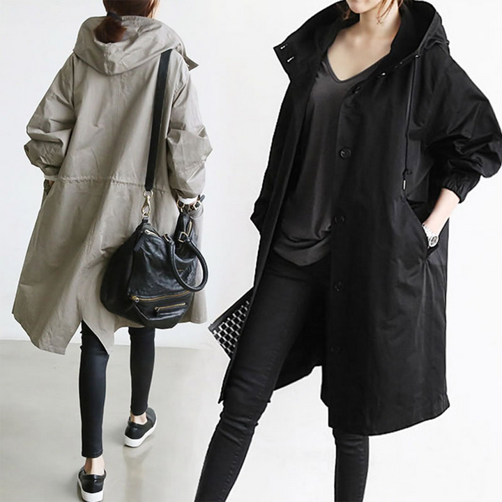 Modern women's long waterproof rain jacket, a stylish trench coat for ultimate weather protection.