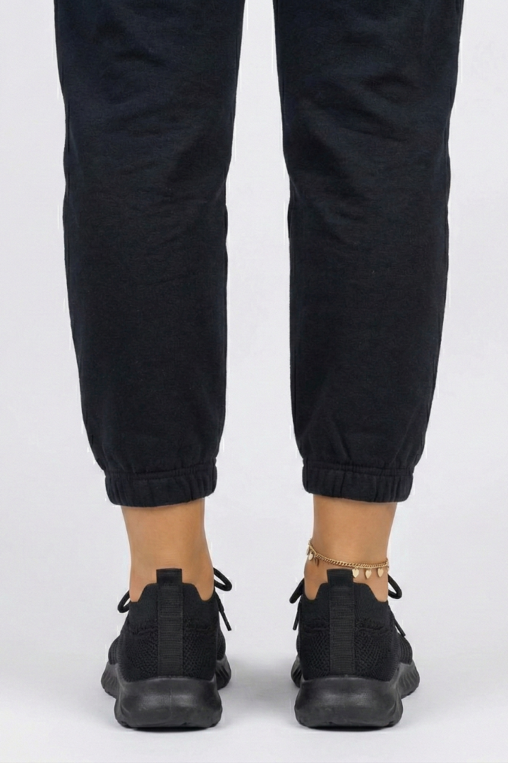 Side view of women's stylish lace-up sneakers, highlighting sleek silhouette and textured grip for active footwear.