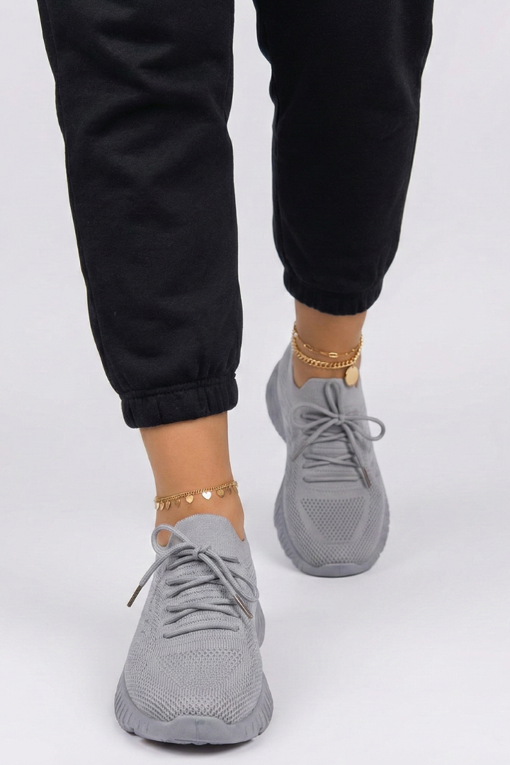Front angle of women's trendy lace-up sneakers, emphasizing laces and breathable design for casual footwear comfort.