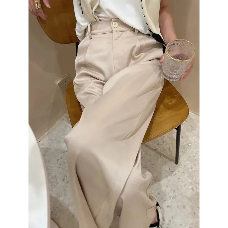 Woman walking in comfortable wide leg high waist loose fit pants, full length, ideal for casual days.