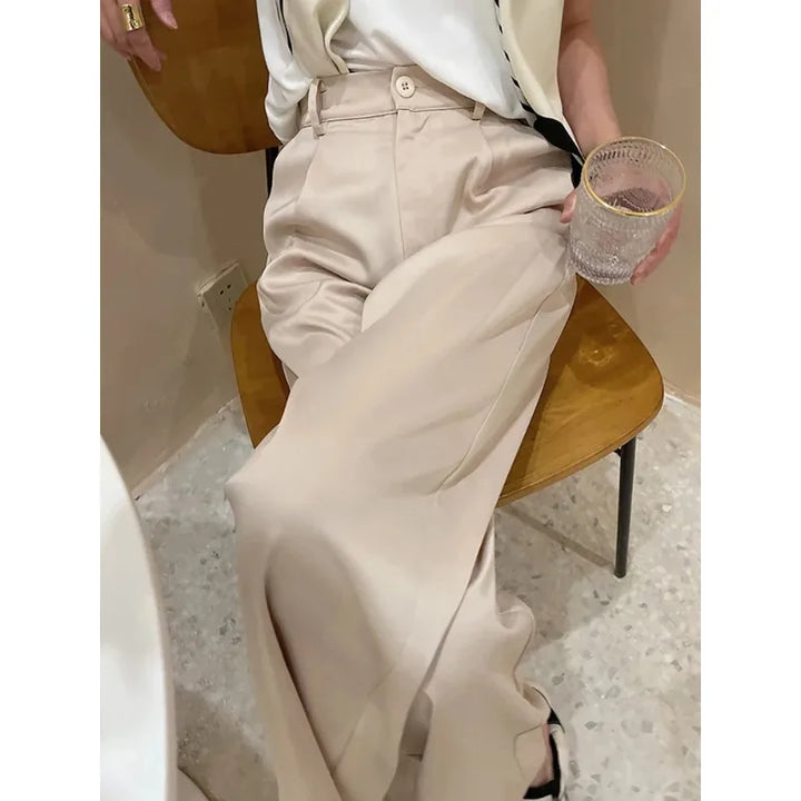 Woman walking in comfortable wide leg high waist loose fit pants, full length, ideal for casual days.