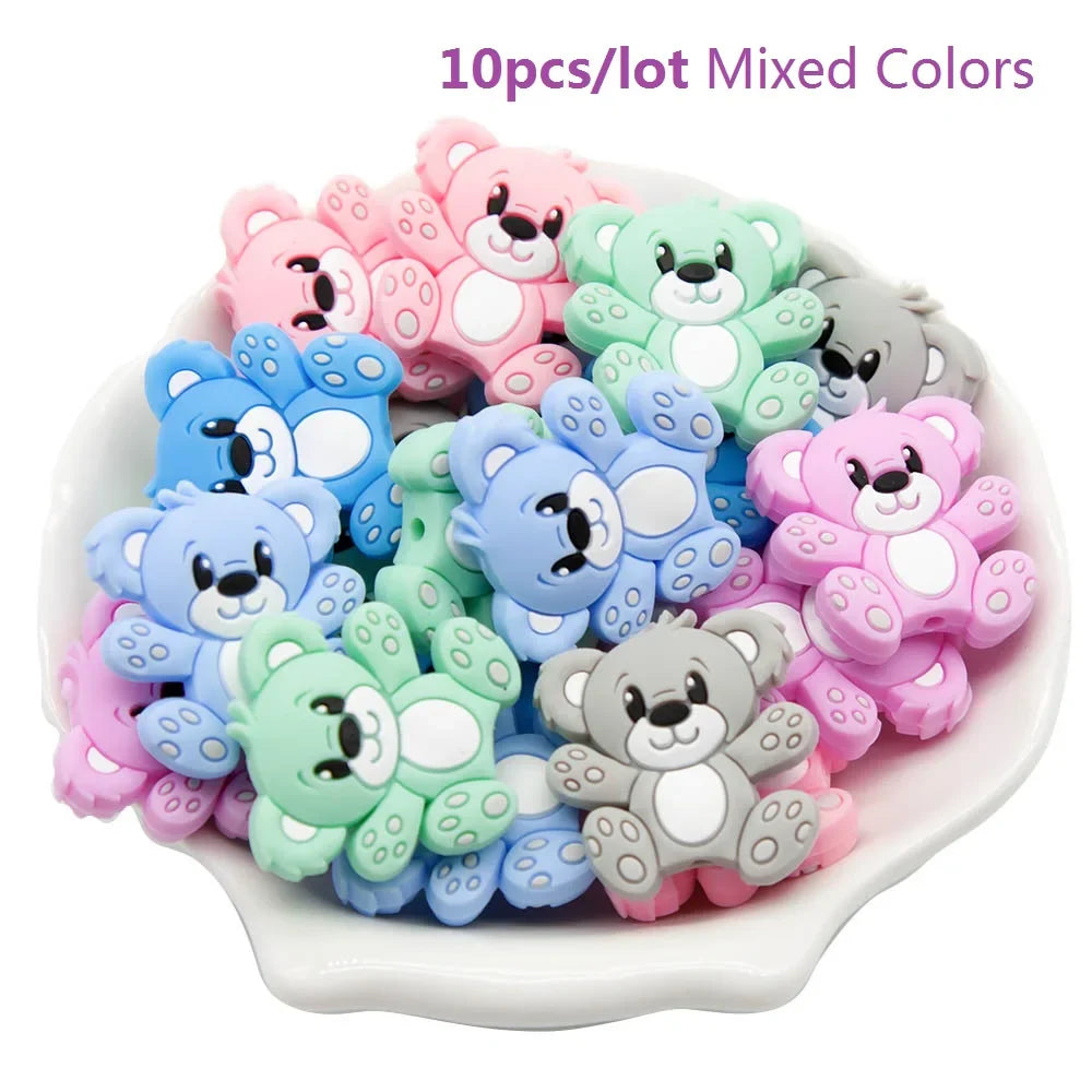 Ten silicone teether beads in pastel shades, great for DIY baby shower gifts & sensory activities.