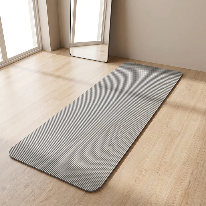 Thick fitness mat for high-impact workouts, offering joint support and comfort for home gym use.