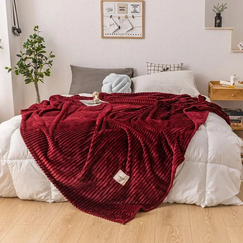 Cozy autumn flannel blanket draped over a sofa, adding warm home decor.