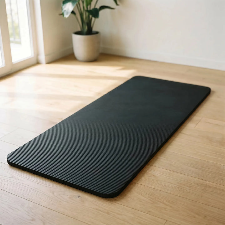 Thick home exercise mat for cushioned yoga, pilates, and fitness workouts.