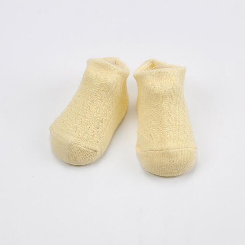 Close-up of a baby anti-slip mesh cotton sock showing soft breathable fabric and grippers