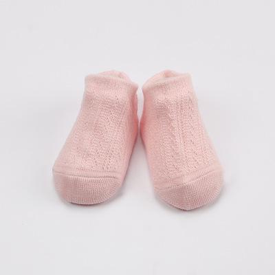 Pair of light-colored baby anti-slip mesh soft cotton socks on a white background, kids fashion