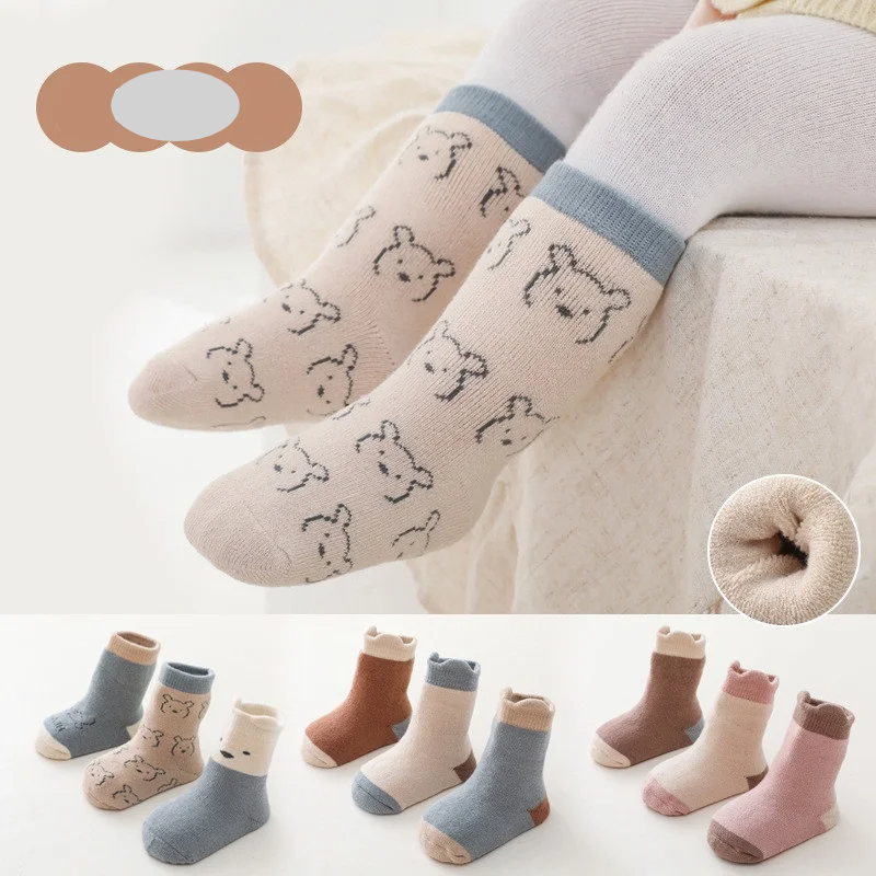 Three pairs of baby's thick warm autumn-winter cotton blend socks in various colors, infant apparel