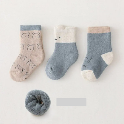 Folded warm baby socks neatly arranged, highlighting their thickness, perfect for autumn winter