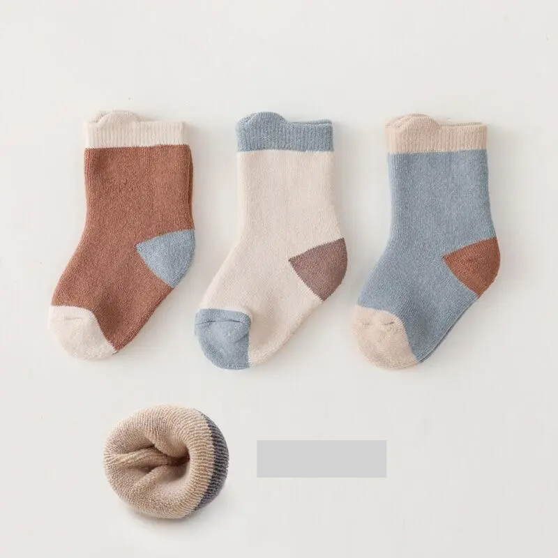 Detailed texture of a warm baby sock, showing the soft cotton blend material, winter apparel