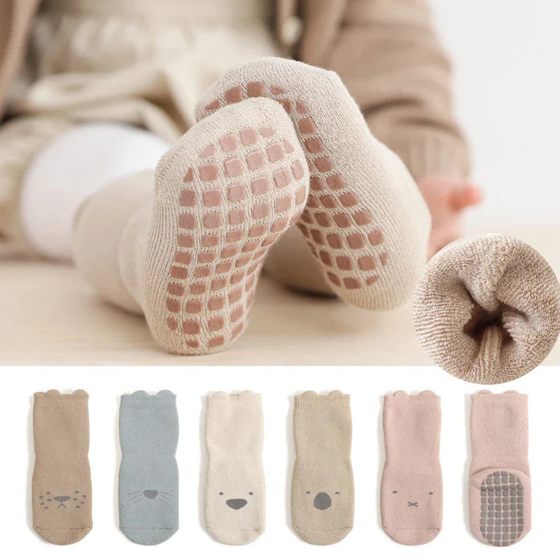 Three pairs of multicolored unisex winter anti-slip cartoon baby socks for newborns and toddlers