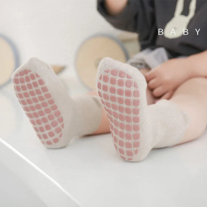 Set of three warm baby winter socks, anti-slip and featuring playful cartoon characters