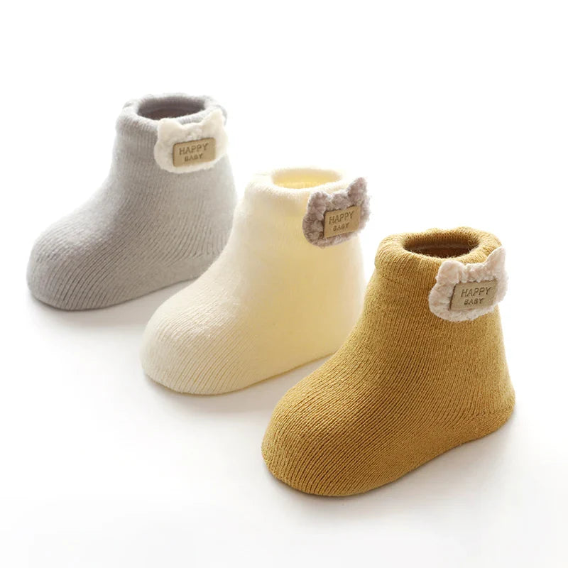 Adorable fox-themed baby socks, part of a three-pair set of warm and soft winter apparel.