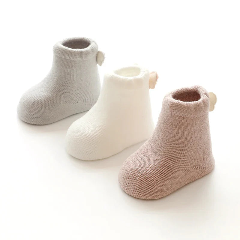 Three pairs of warm baby animal socks, a perfect gift for newborns and toddlers in winter.