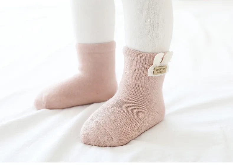 Soft winter baby socks with cute animal faces, designed for comfort and style for little ones.