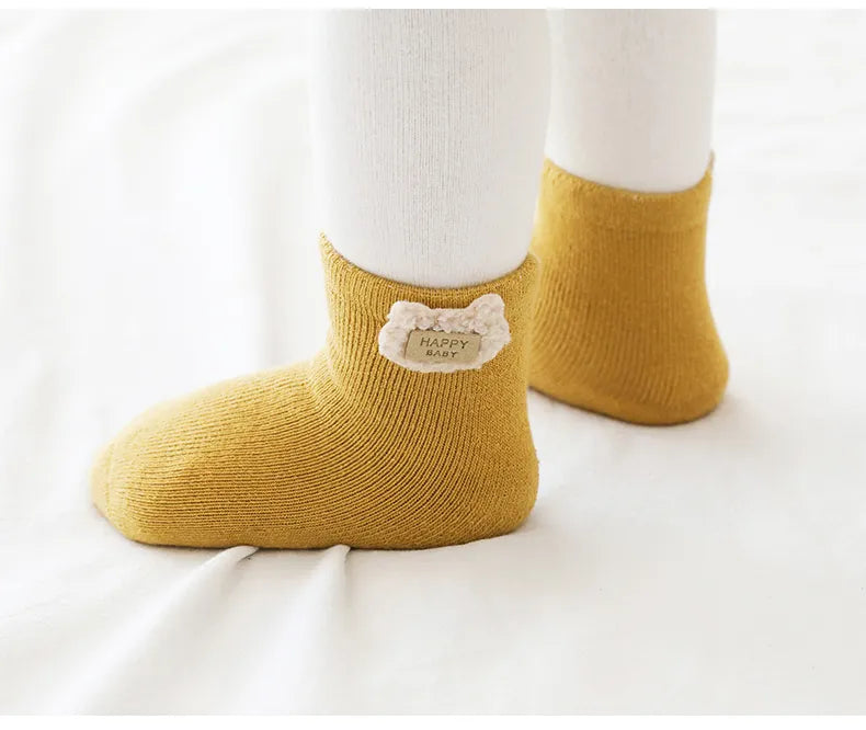 Close view of the high-quality cotton blend material of the warm animal baby socks.