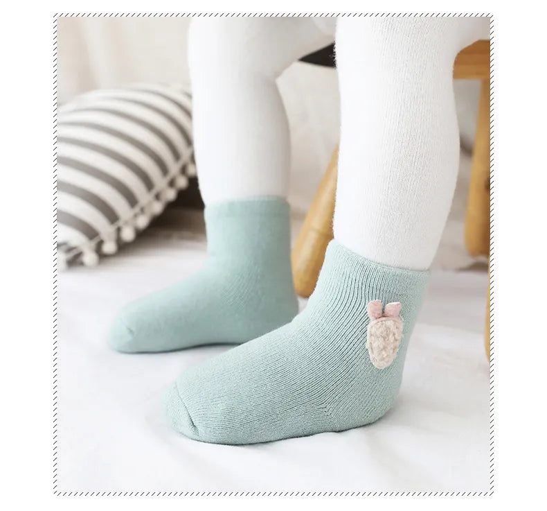 Warm cotton blend baby socks with cute animal designs, including a playful rabbit pattern.