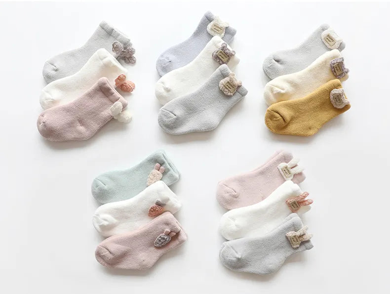 Baby accessories: three pairs of warm, soft, and cute animal-themed winter socks for unisex wear.