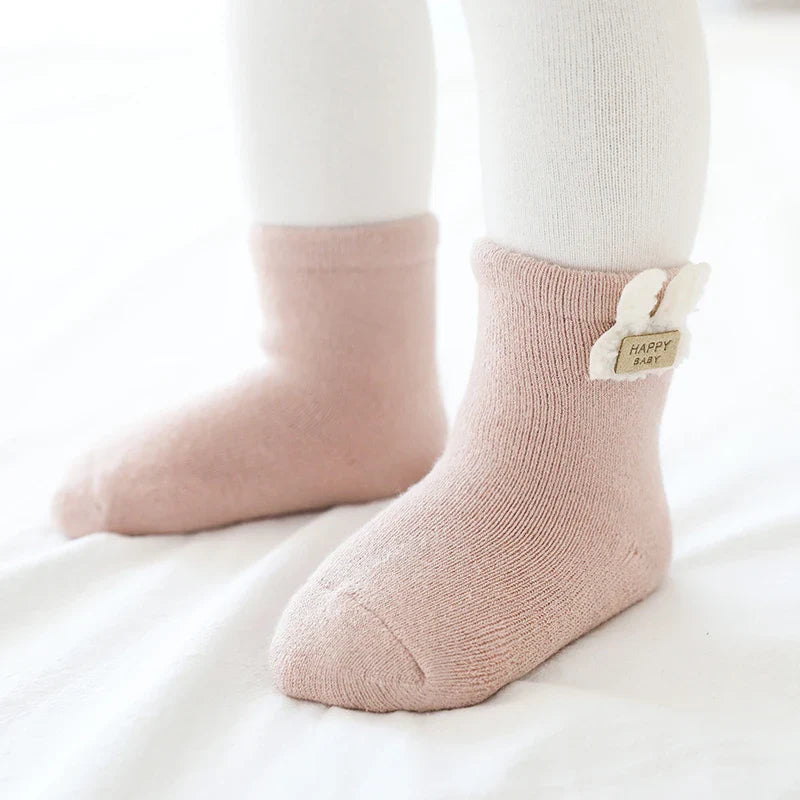 Unisex baby winter socks, three-pack featuring bear, fox, and rabbit designs on a white background.