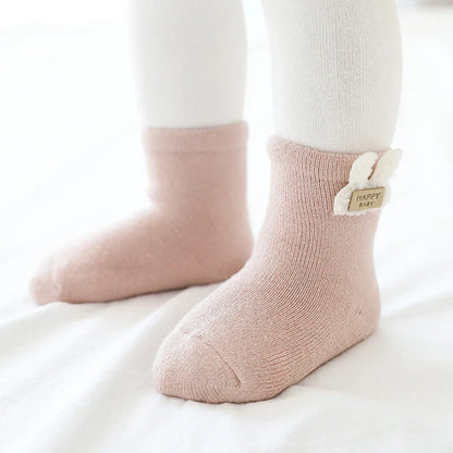 Unisex baby winter socks, three-pack featuring bear, fox, and rabbit designs on a white background.