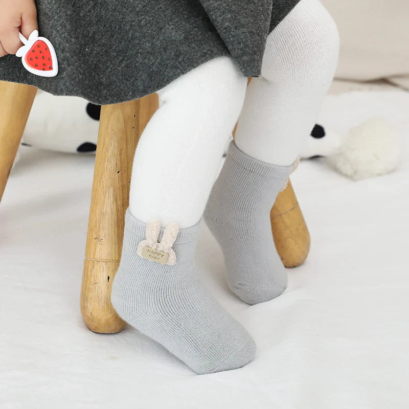 Infant warm socks with cute animal patterns, ideal for keeping baby's feet cozy in winter.
