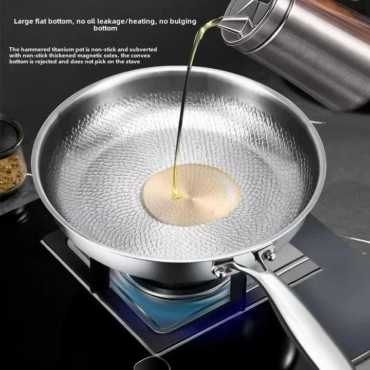 Modern hammered titanium frying pan, non-stick and induction-ready, essential for any kitchen.