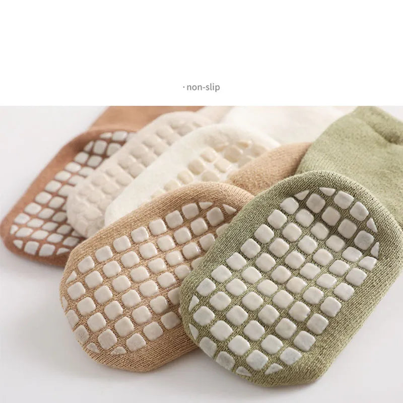Cozy baby anti-slip cartoon polka dot socks, comfortable winter footwear for home.