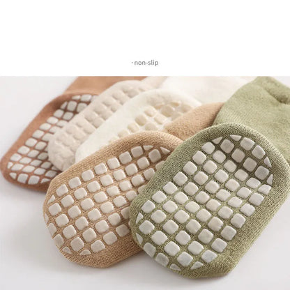 Cozy baby anti-slip cartoon polka dot socks, comfortable winter footwear for home.