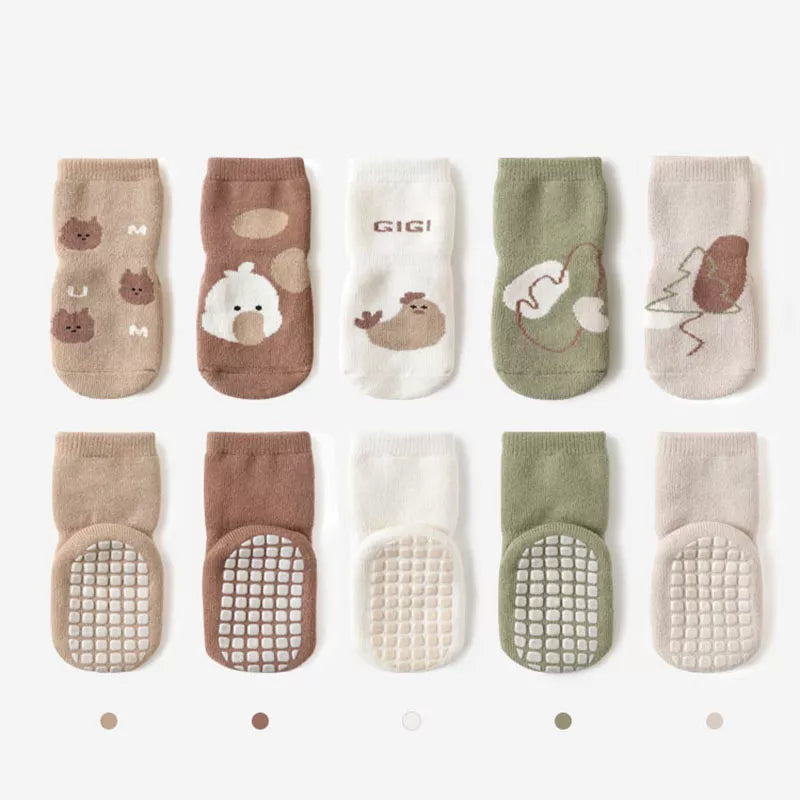 Toddler non-slip cartoon striped socks, soft and grippy winter footwear for infants.