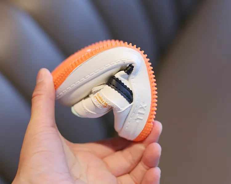 Bottom view of kids' anti-slip shoes, showcasing patterned tread for superior grip