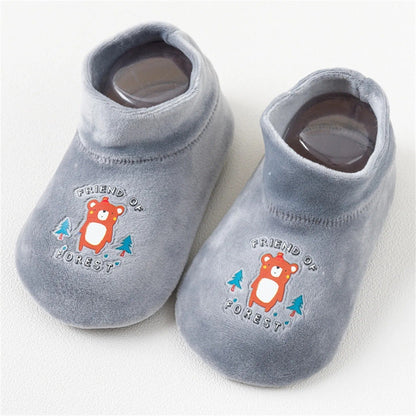 A pair of yellow kids anti-slip sock shoes, combining warmth and safety for active toddlers.