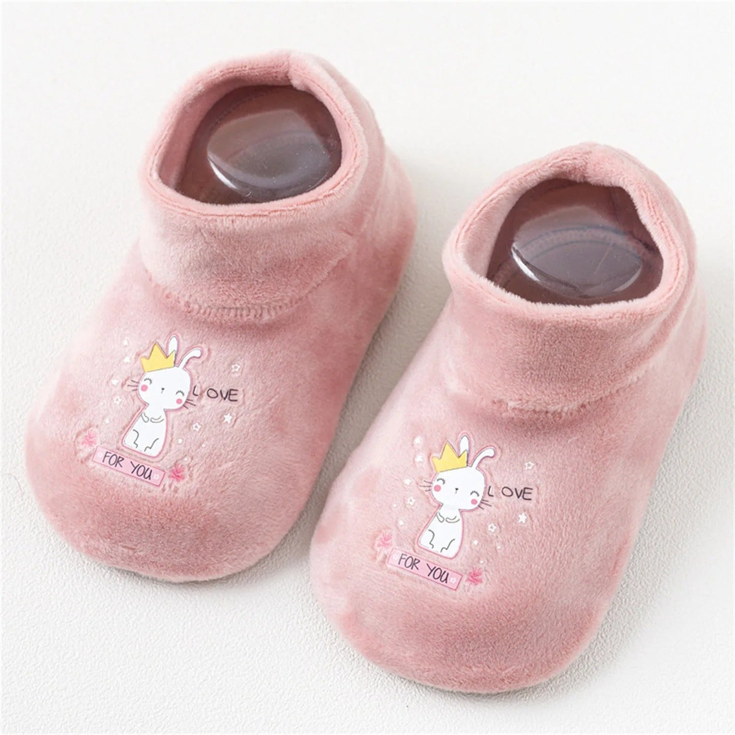 Cute cartoon-themed anti-slip baby footwear in orange, designed for comfort and grip on smooth floors.
