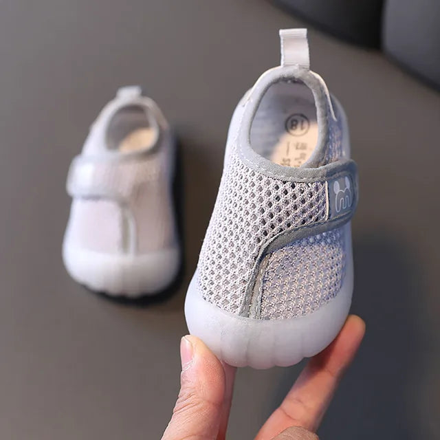 Side view of grey toddler anti-slip mesh shoes, comfortable and breathable summer footwear.