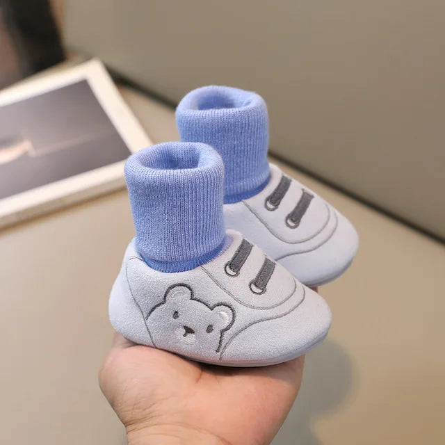 Close-up of softsole toddler anti-slip socks, blue, designed for infant first walkers and comfort