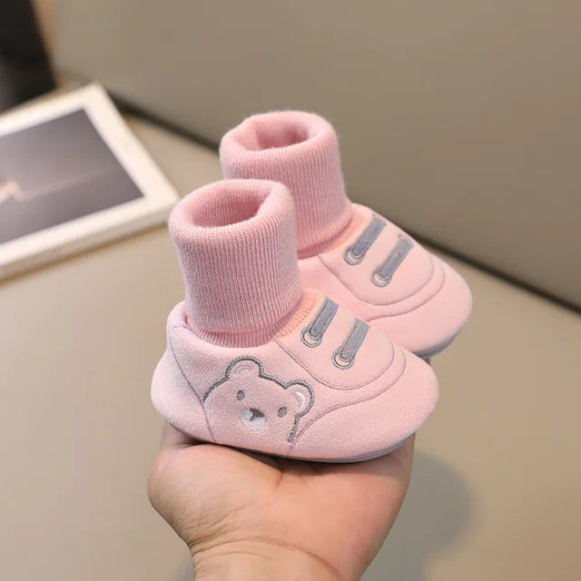 Pair of colorful anti-slip sneaker socks for toddlers, ideal as baby shoes for first steps