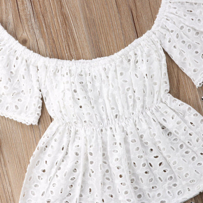 Newborn girl's elegant summer outfit featuring a white lace peasant top and comfortable blue shorts