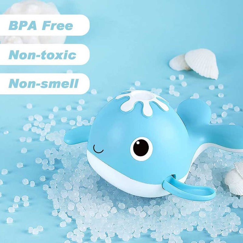 Educational bath toy fishing game showing a red magnetic rod and floating wind-up whales