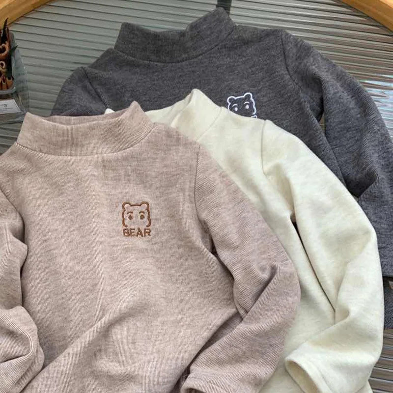 Front view of a cozy bear fleece turtleneck shirt, soft toddler apparel