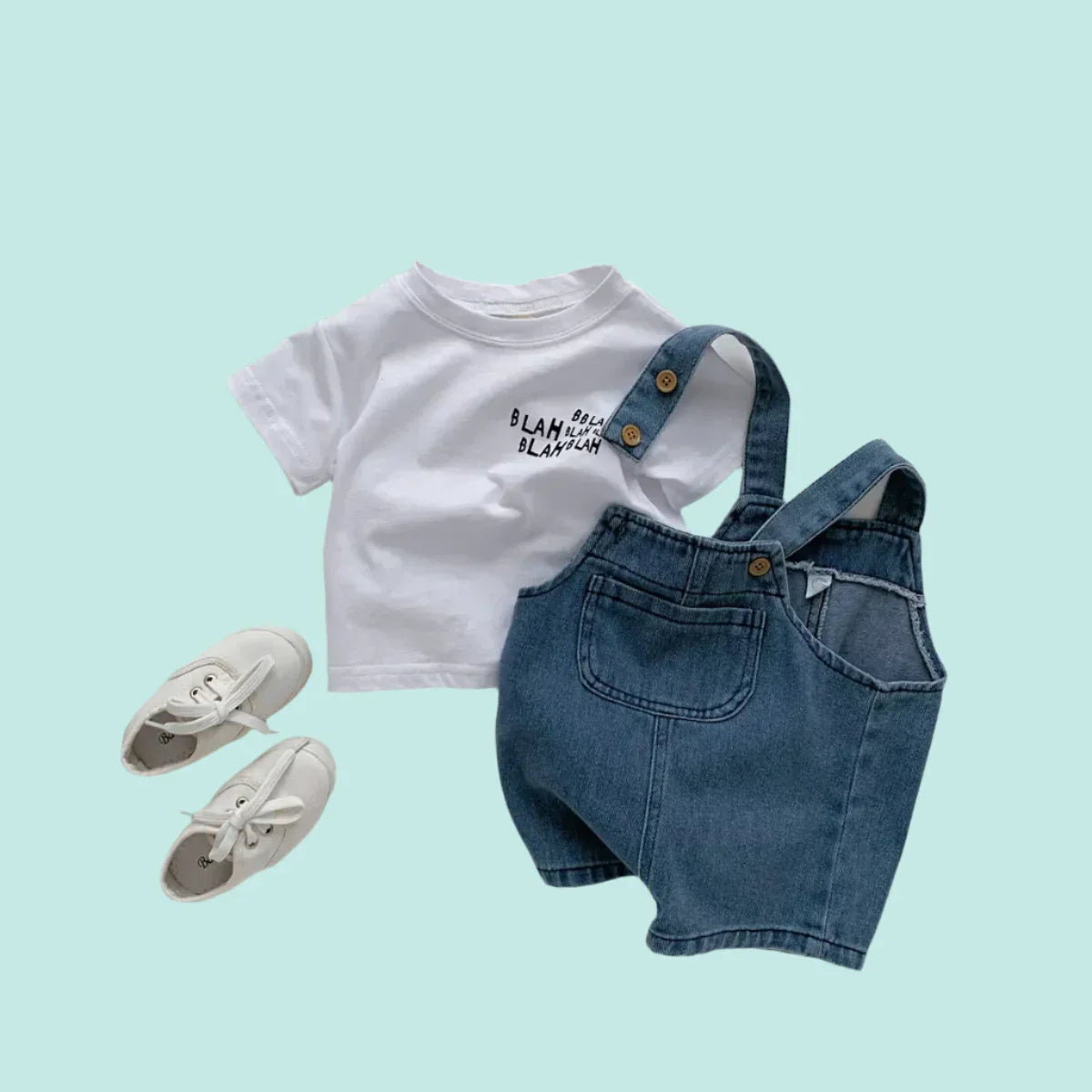 Toddler boy in blue denim t-shirt and matching jumpsuit set, front view, comfortable summer outfit.