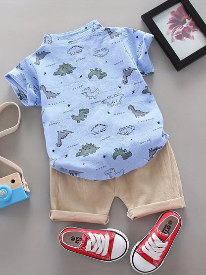 Close-up of a smiling boy in a blue dino print top and shorts, comfortable toddler summer wear set