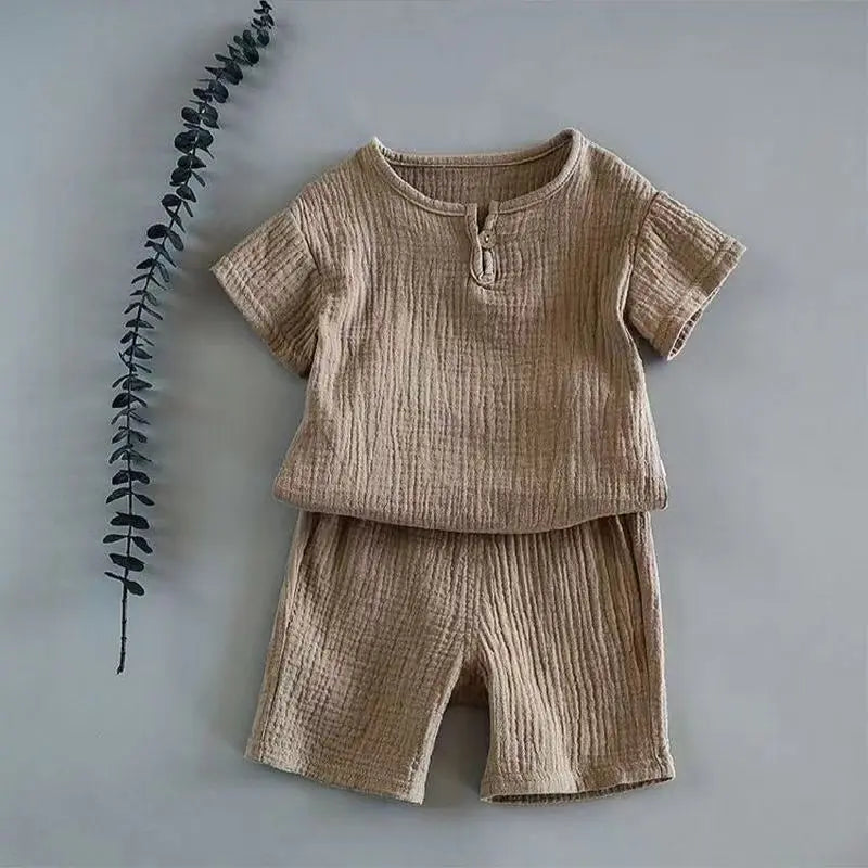 Back view of a boy wearing a comfortable linen cotton t-shirt and shorts outfit