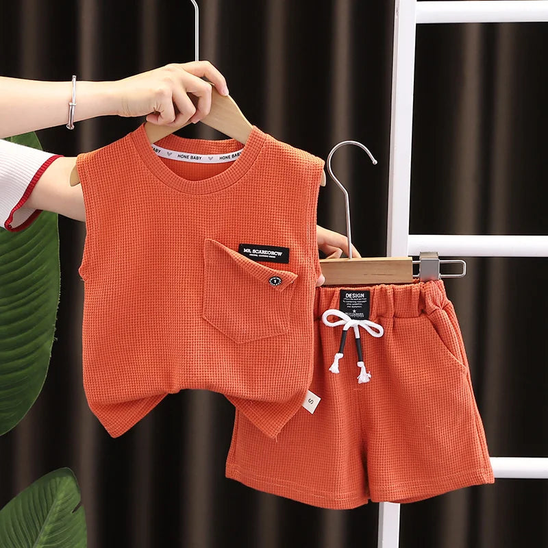 Toddler boy's orange sports shorts with elastic waistband, perfect for active summer play, durable kids clothing.